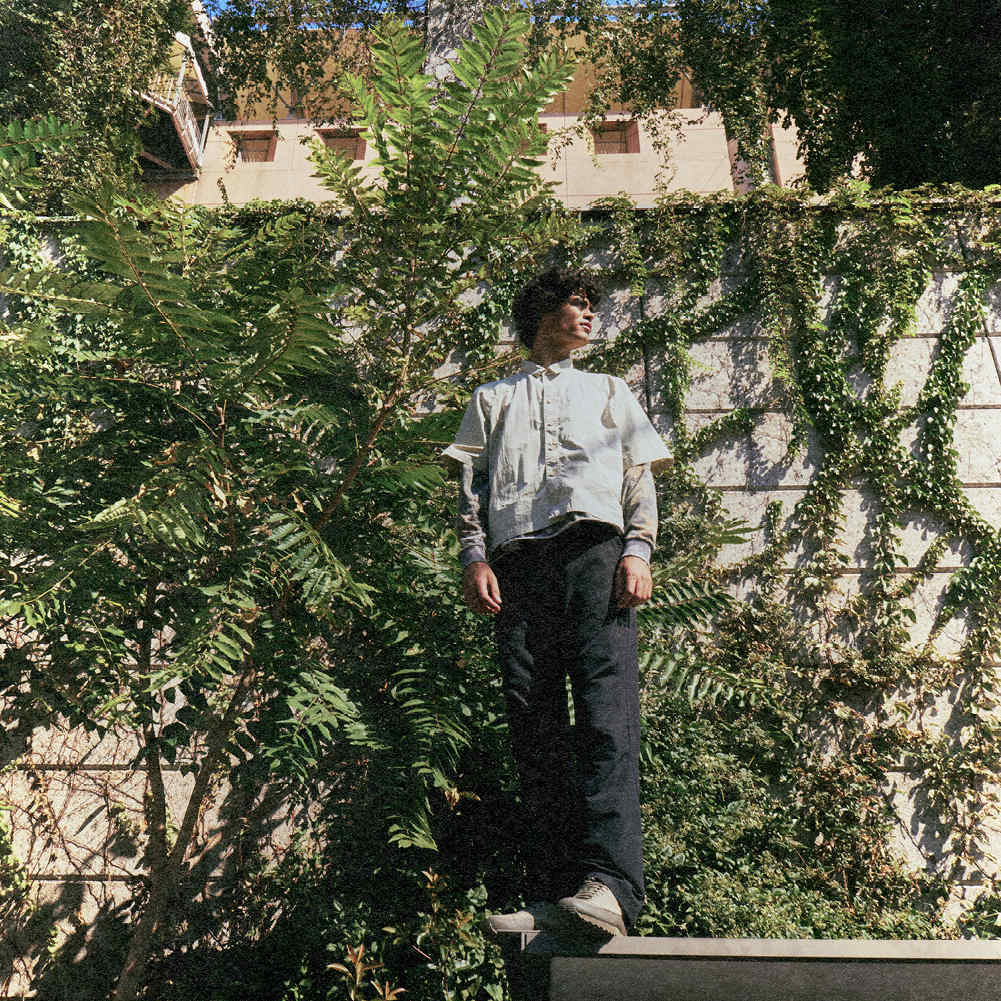 A man standing wearing Saxifraga 3.0 shoes in a lifestyle and urban context.