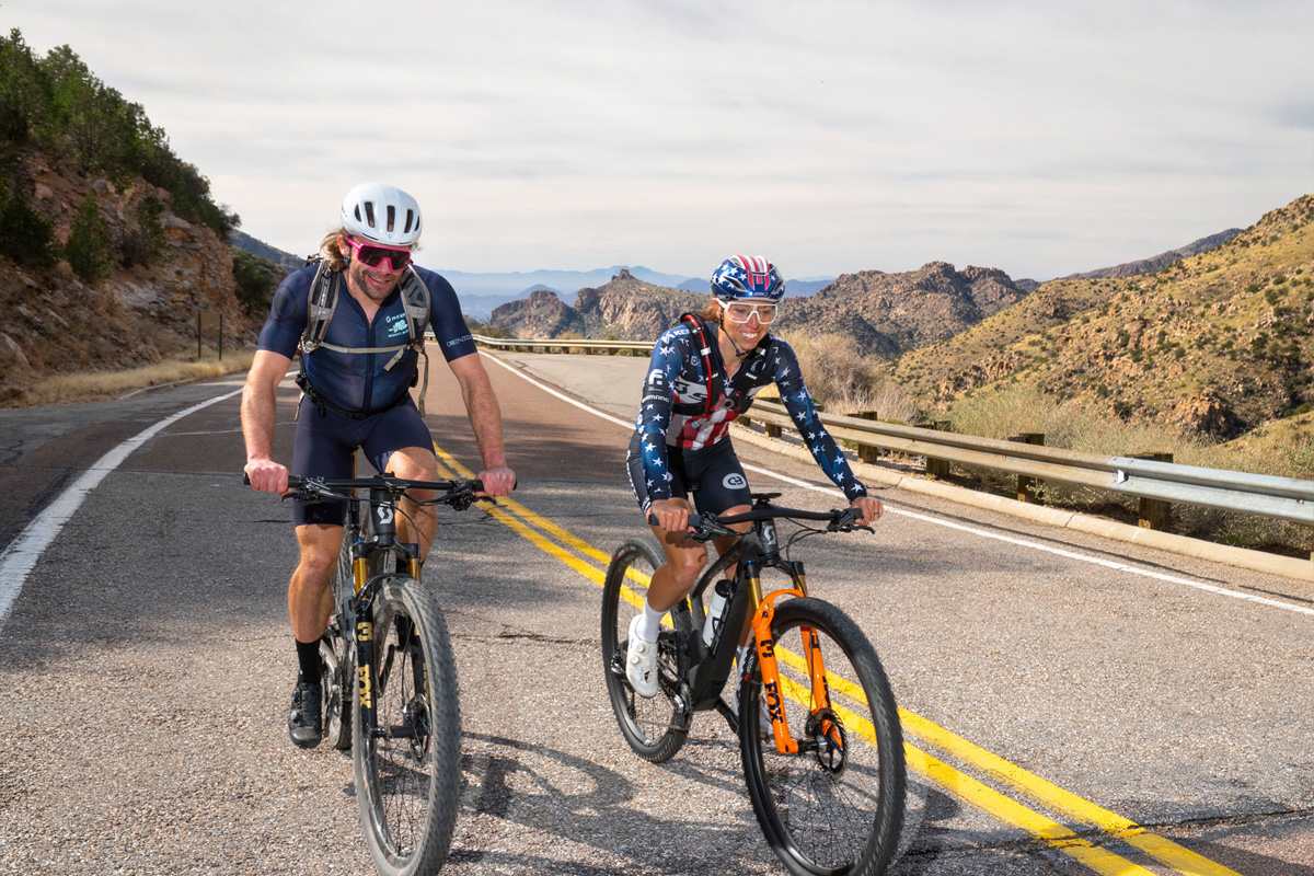 Ryan Standish and Hannah Otto riding a paved mountain road near Tucson, Arizona