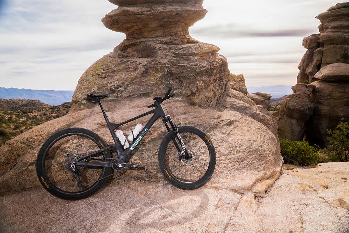 SCOTT Spark mountain bike propped against a desert rock formation