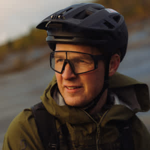 Scotty Laughland, an athlete, is shown wearing a helmet and displaying a cheerful expression.